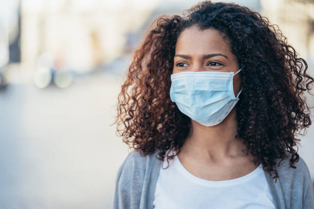 istock Woman with face protective mask 1214338193