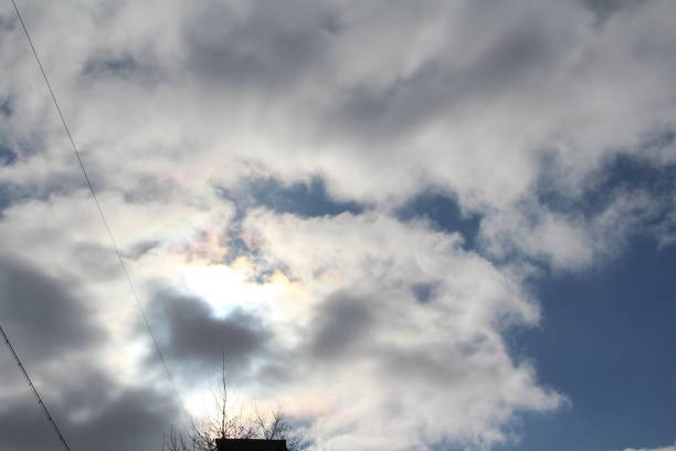 istock White clouds on a blue sky. Background for text and design. The sun behind the clouds, shines through 1214339638