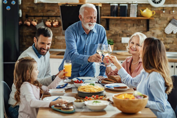 istock Family toast at dining table! 1214340759