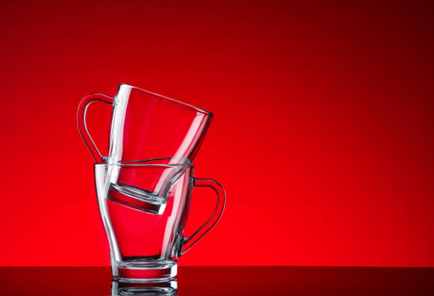 istock Crystal glasses shot close-up on a red background 1214340916