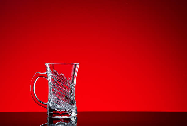 istock Crystal glasses shot close-up on a red background 1214340957