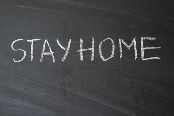 istock Hashtag stay at home. Outbreak Warning. written white chalk on blackboard in connection with epidemic of coronavirus worldwide. 1214341039