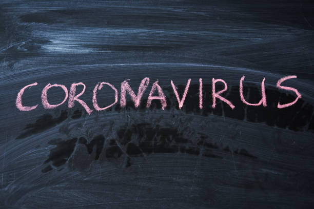 istock Outbreak Warning. written white chalk on blackboard in connection with epidemic of coronavirus worldwide. 1214341068