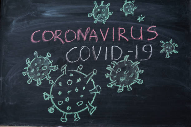 istock Outbreak Warning. written white chalk on blackboard in connection with epidemic of coronavirus worldwide. 1214341111