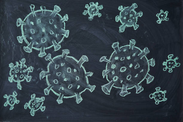 istock Outbreak Warning. written white chalk on blackboard in connection with epidemic of coronavirus worldwide. 1214341208