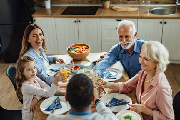 istock Cheerful extended family having fun while toasting during lunch. 1214341239