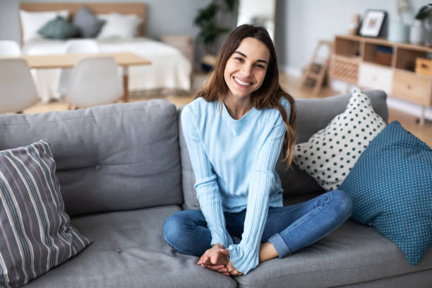 istock Beautiful woman relaxing on sofa at home. 1214342326