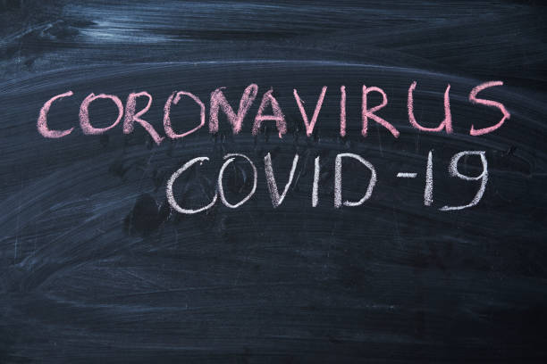 istock Outbreak Warning. written white chalk on blackboard in connection with epidemic of coronavirus worldwide. 1214342398