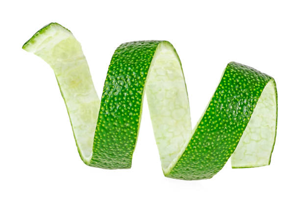 istock Curly lime peel twist isolated on a white background, front view. 1214342524