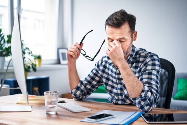 Frustrated, overworked freelancer working from home office Frustrated, overworked freelancer working from home office exhaustion stock pictures, royalty-free photos & images