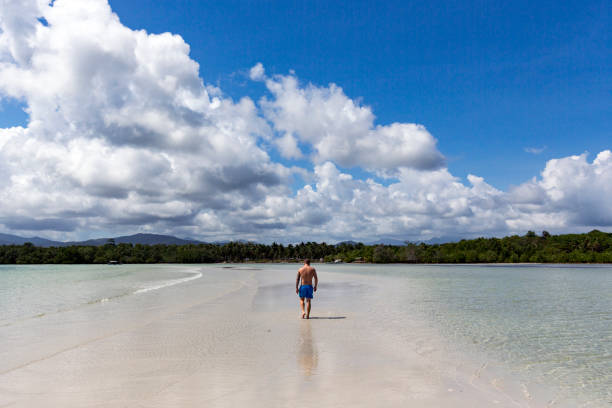 istock A young man takes a walk on a sand dune between two waters in a Puerto Princesa beach, Palawan, Philippines 1214343993