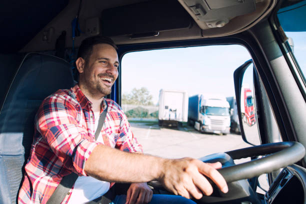 truck driver job. middle aged trucker driving truck. - semi truck fotos imagens e fotografias de stock