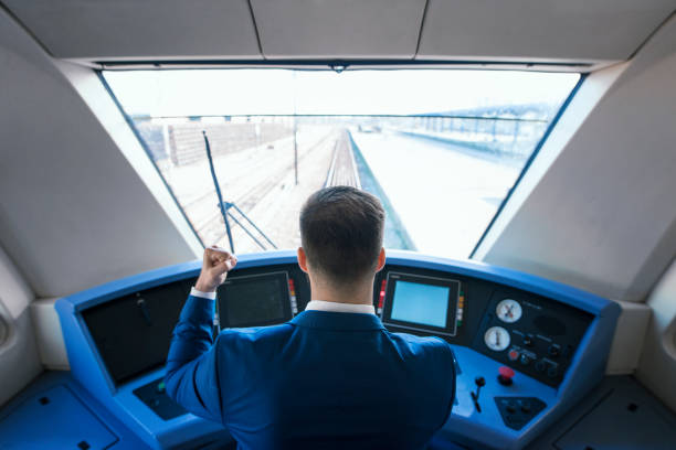 Train subway driver holding fist in the air. Successful public transportation. Top view of subway driver arriving to the station on time with his high speed train. train interior stock pictures, royalty-free photos & images