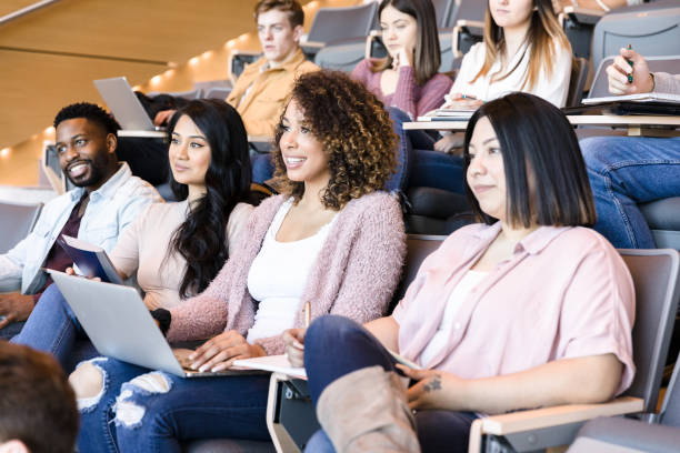 istock Confident college students listening to professor 1214345211