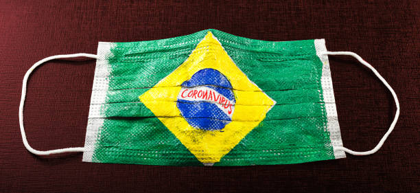 istock respiratory mask with the texture of flags from countries contaminated by coronavirus. Background image with pandemic concept, contagion by covid-19. Quarantine Brazil 1214347575