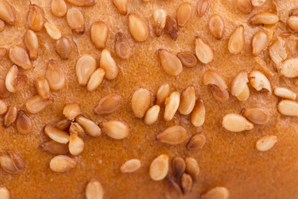 istock Fragment of bun with sesame seeds. 1214347742