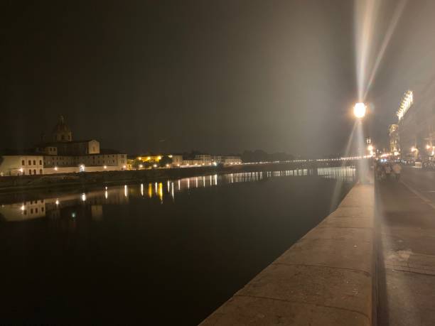 istock Street light above Arno River at night 1214348024