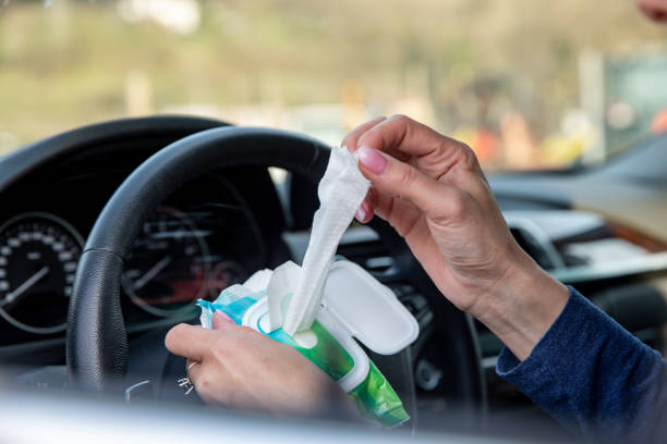 istock Using Wet Wipe to sanitize the Steering wheel 1214348252