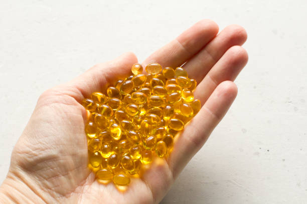 Capsules are in palm, hand food supplement oil filled capsules vitamin A, vitamin D3, fish oil, omega 3, 6, 9, evening primrose, borage oil, flax seeds oil, vitamin D, vitamin E. Copy space your text. las cápsulas están en palma, cápsulas llenas de aceite de suplemento alimenticio de mano vitamina a, vitamina d3, aceite de pescado, omega 3, 6, 9, onagra, aceite de borage, aceite de semillas de lino, vitamina d, vitamina e. copie el espacio de su text