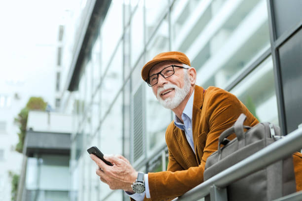 Senior Man Outdoors with glasses in front of office
