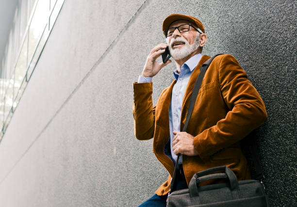 istock Senior Man Outdoors with glasses talking on smart phone 1214350983