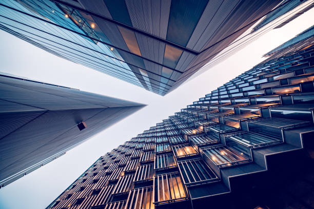 Looking directly up at the skyline of the financial district in central London - stock image Highly detailed abstract wide angle view up towards the sky in the financial district of London City and its ultra modern contemporary buildings with unique architecture. Shot on Canon EOS R full frame with 10mm wide angle lens. Image is ideal for background. Toned image. skyscraper stock pictures, royalty-free photos & images