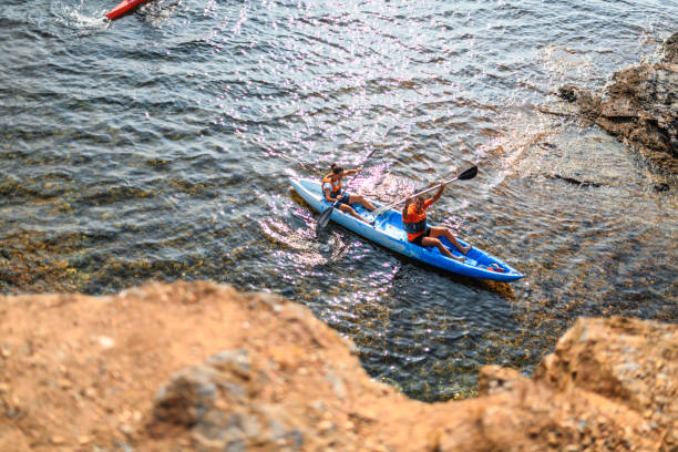 istock Spanish Kayakers Exploring Rocky Coastline of Mediterranean 1214353589