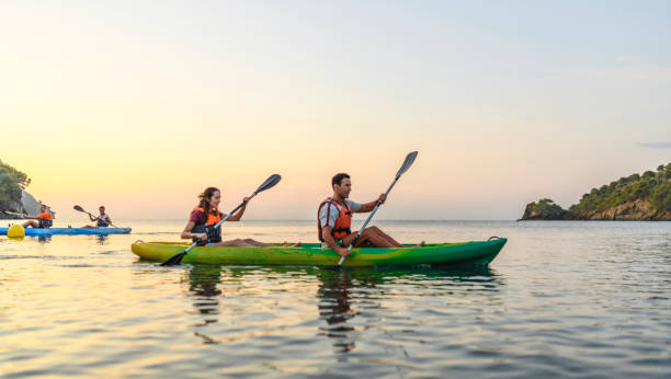 istock Spanish Couples Paddling Kayaks in Mediterranean at Dawn 1214353617