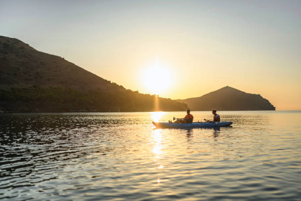 istock Spanish Kayakers Resting in Calm Mediterranean at Sunrise 1214353622