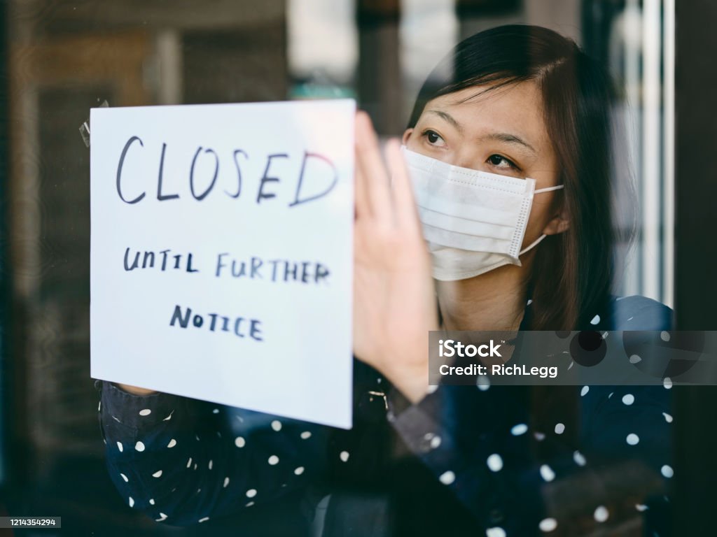 Small Business Owner Affected by COVID-19 An Asian woman small business owner affected by the COVID-19 virus. Coronavirus Stock Photo