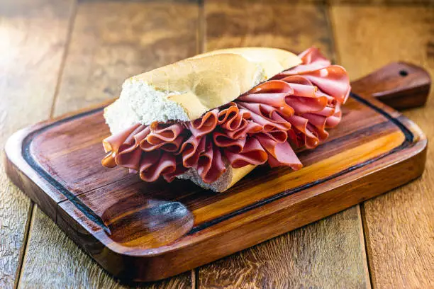 Photo of Traditional mortadella sandwich from Mercado Municipal (Mercado Municipal) in São Paulo, Brazil. Great snack of bread with mortadella.