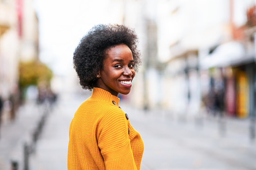 Portrait of a beautiful smiling African-American woman in the city.