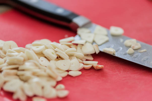 Long Exposure of a long kitchen knife cutting vegetables