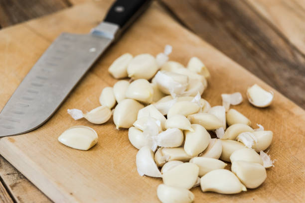 istock Garlic chopped at chopping board, close-up 1214365182