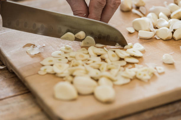 istock Garlic chopped at chopping board, close-up 1214365197