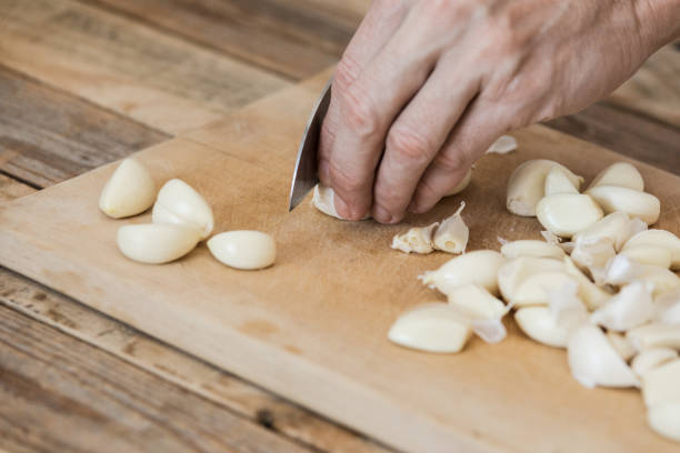 istock Garlic chopped at chopping board, close-up 1214365738