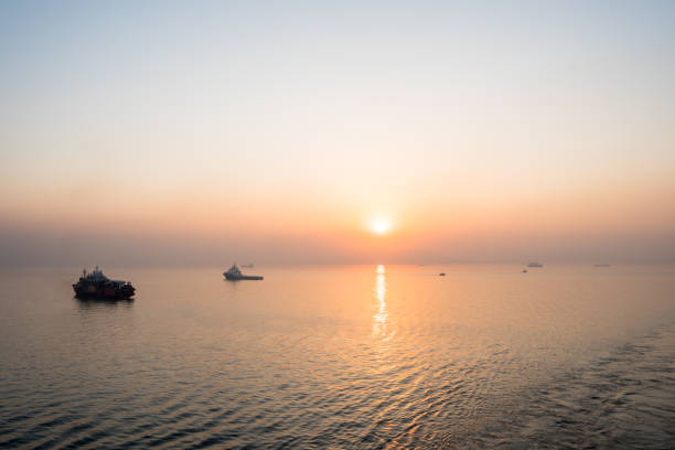 istock Commercial shipping moored off Mumbai by sunset. 1214365861