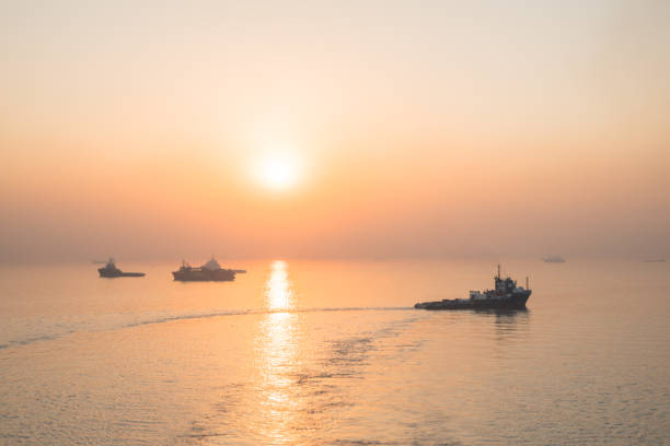 istock Commercial shipping moored off Mumbai by sunset. 1214365919