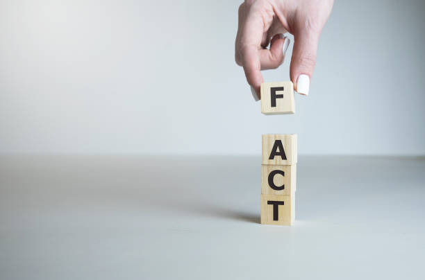 istock Hand hold Wooden cubes with word FACT on table. Cubes with letters 1214366029