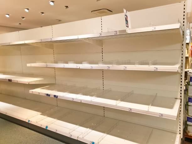 istock Empty goods shelves in a supermarket 1214367733