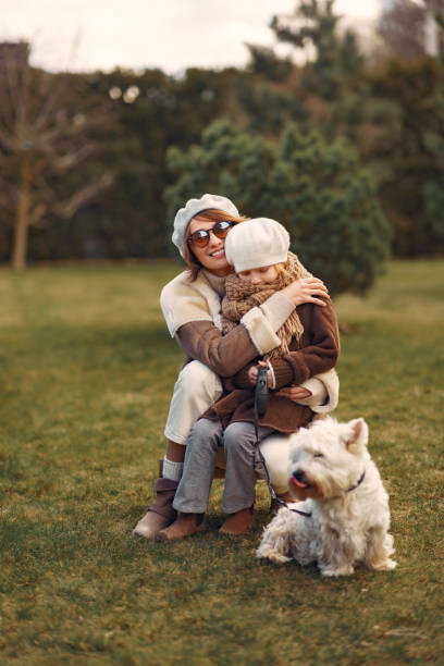 istock Mother with daughter walks with a dog 1214368192