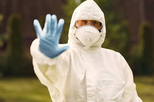istock Person in a protective suit in a park 1214369252