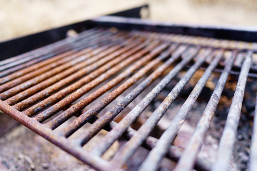 Barbecue Grill Outdoor Picnic - Steel metal grill detail with selective focus and soft bokeh.