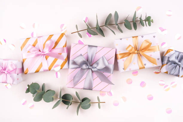 Set of gift boxes with bows and confetti on a white background.