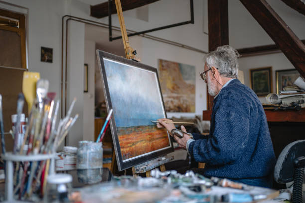 istock Serene senior artist working on a new painting 1214373349