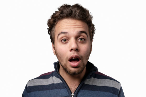 istock Portrait of shocked young man over white background 1214373353