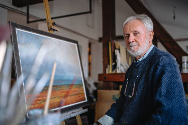 istock Senior artist painting in an art studio 1214373425