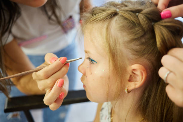 istock Children make up. Glitter makeup. Sparkles on cheek. 1214374031