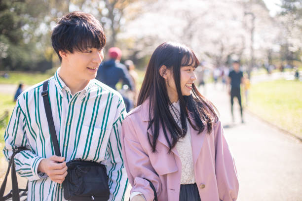 Happy couple looking at something in public park