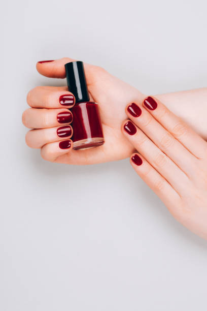 istock Female hands with nail polish 1214375431